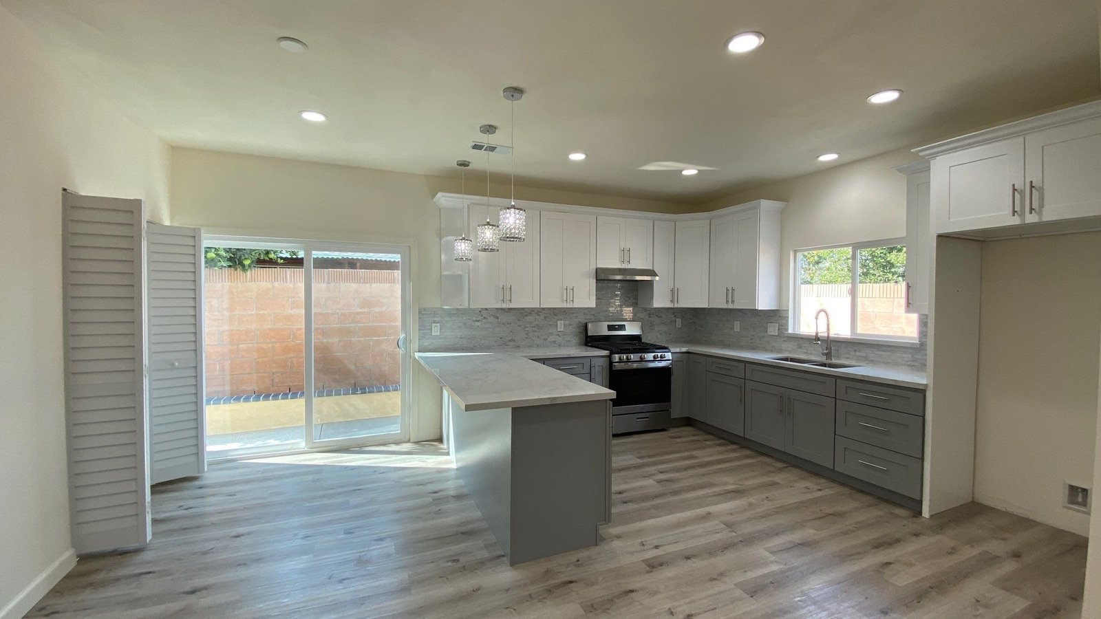 a kitchen with a large window and a stove top